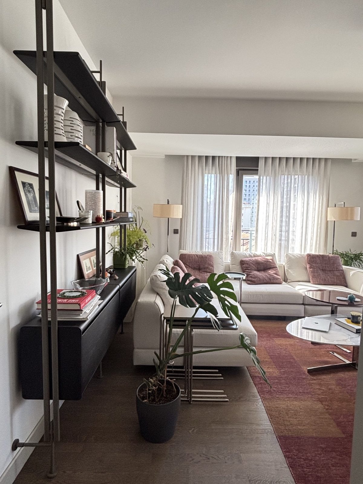 Living room with vintage shelving and warm textiles